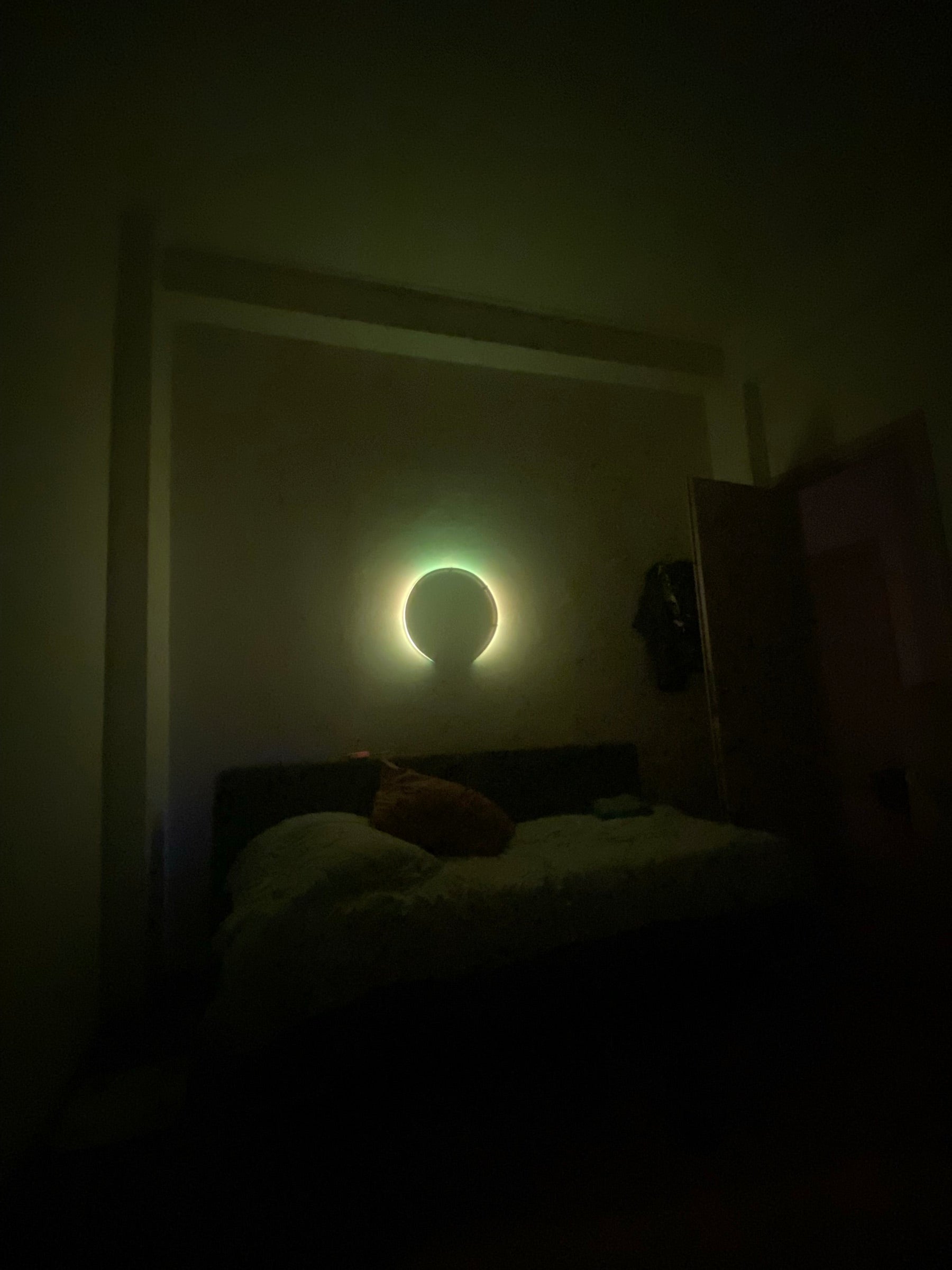 Circular Glow Line installation above a bed